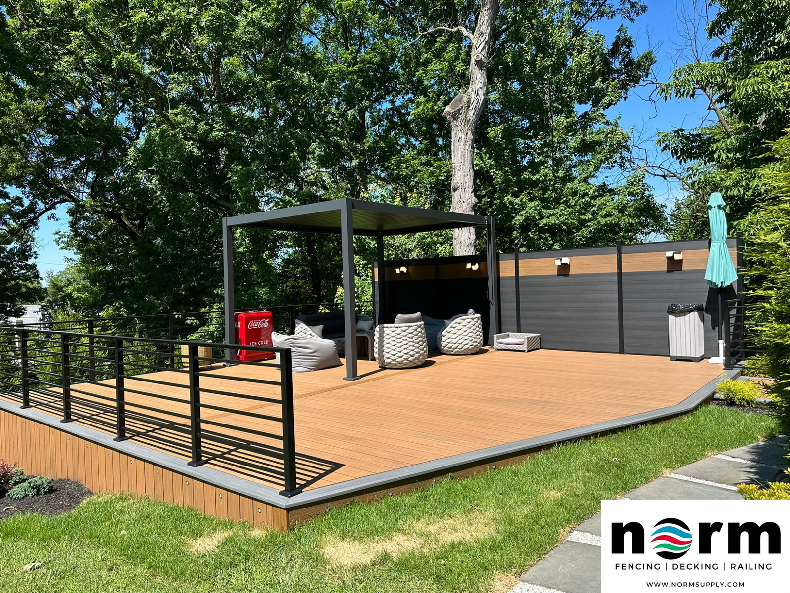 Backyard deck installation with natural wood-style deck boards and modern landscaping.