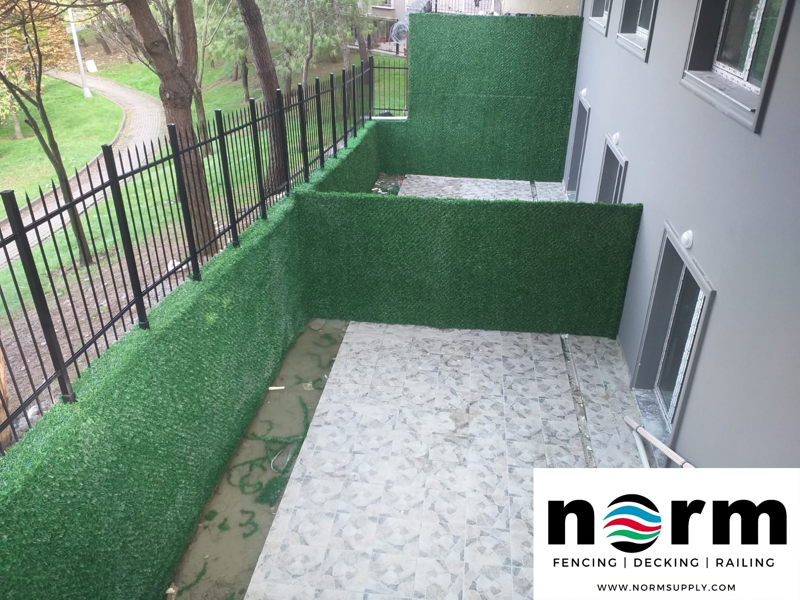 Grass privacy screen installed in backyard for full coverage and stylish fencing solution