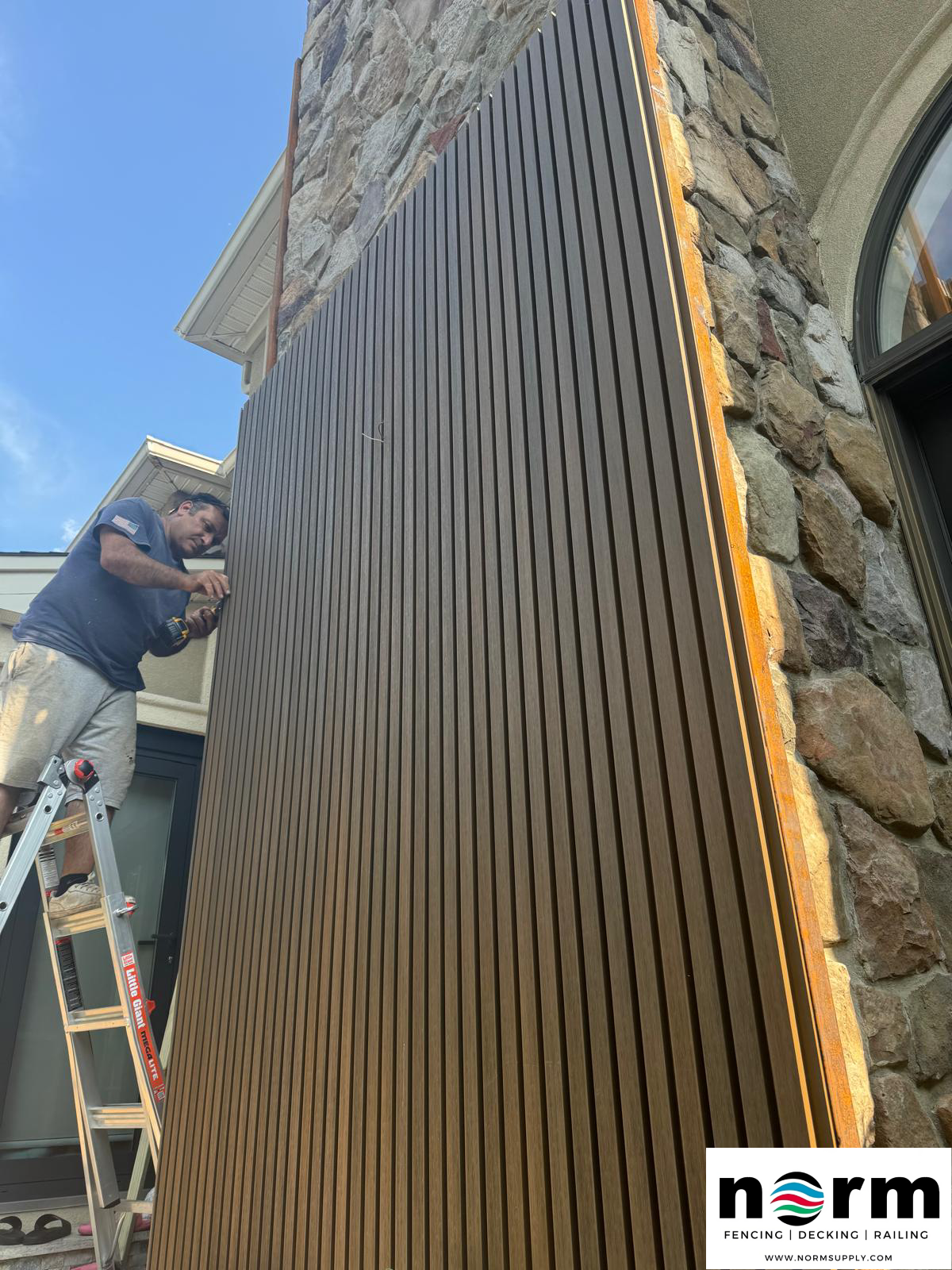 Wall panel installation in progress – Norm Atlanta team member working on exterior panel board system in Stone Mountain, Georgia.